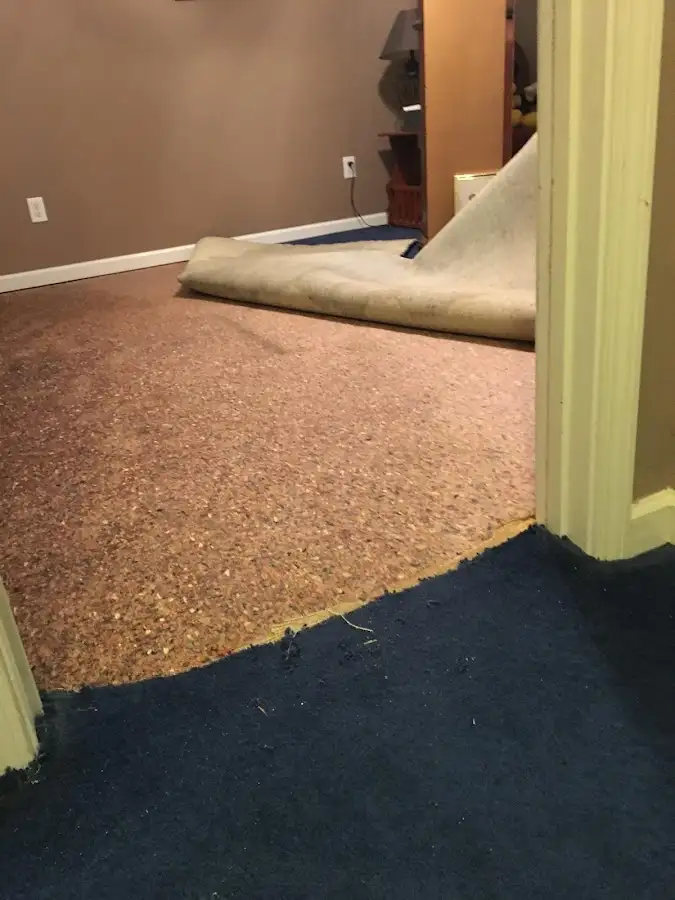 Carpet pad removal revealing water damage during Water Mitigation Services in Lewisburg